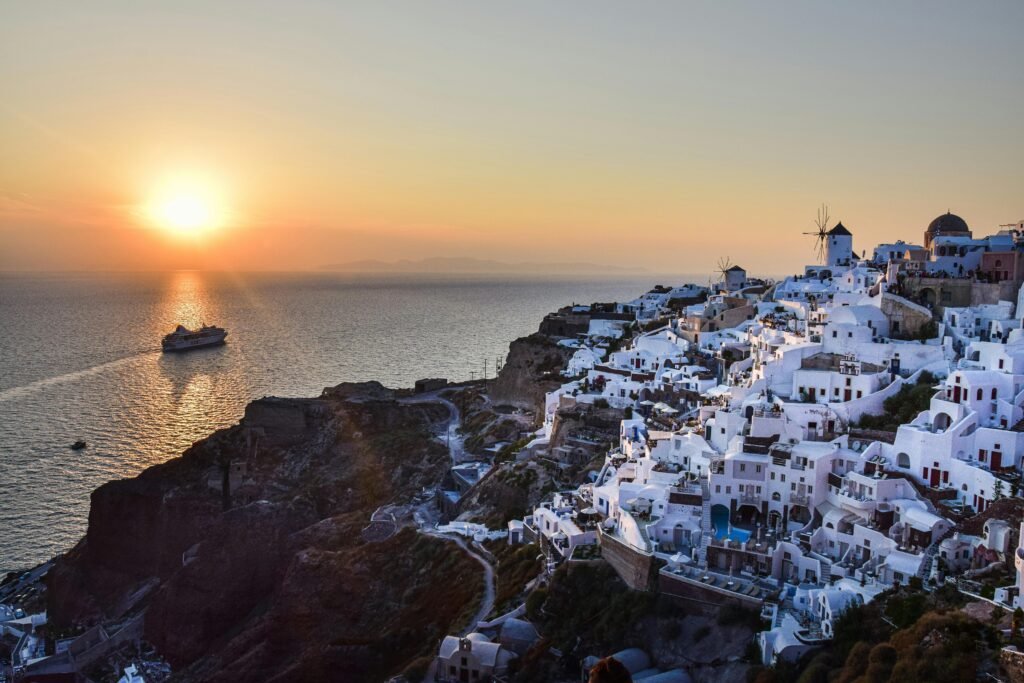 image-santorini-sunsetthtaking sunset view over Santorini's white buildings and blue domes